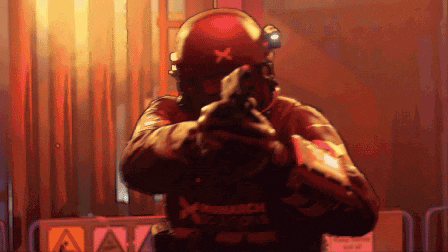a pixelated image of a fireman holding a gun with the word monarch on his vest