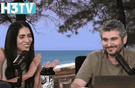 a man and a woman are sitting in front of microphones with a h3tv sign above them