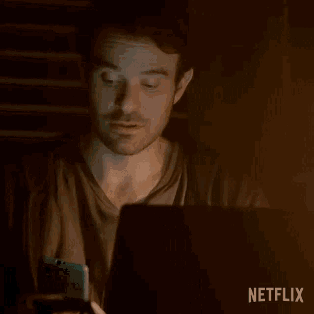 a man sitting in front of a laptop with the word hey written on the screen