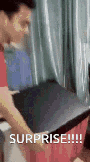 a man is opening a box with the words surprise !!! written on it