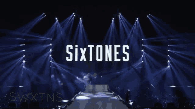 a stage with sixtones written on it in white letters