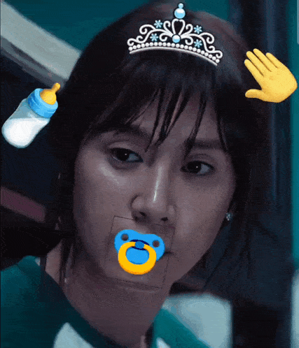 a woman with a pacifier in her mouth wearing a tiara