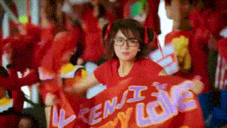 a woman in a red shirt holds a sign that says " when i love you "