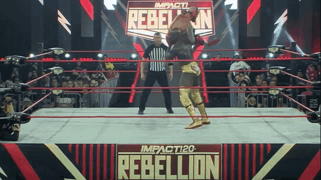a wrestler in a ring with a sign that says rebellion