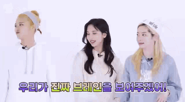 three girls are standing next to each other on a white background and smiling .