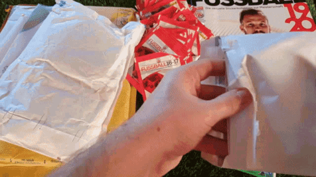 a person is holding a package that says fussball18-17 on it