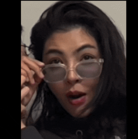 a close up of a woman wearing sunglasses with her mouth open