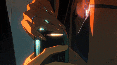 a man with glasses and earrings is kissing another man on the cheek