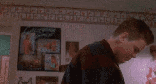 a boy is standing in a room with the words do n't you know how to knock