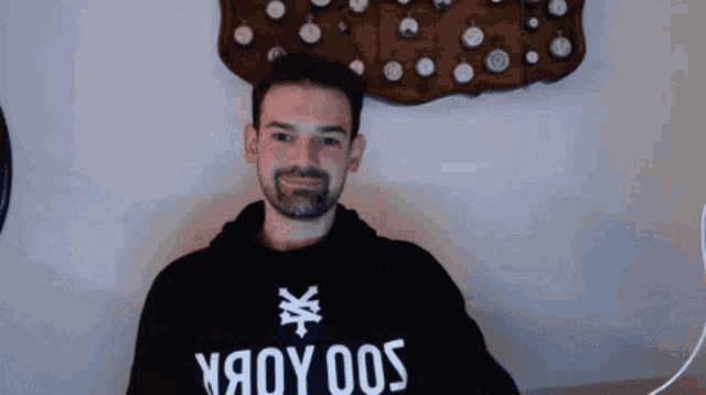 a man wearing a black hoodie that says yяoy 005
