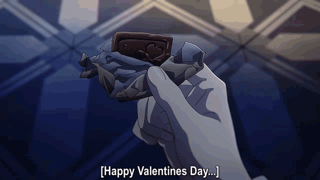 a person holding a piece of chocolate that says " happy valentines day " on the bottom