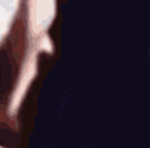a close up of a person 's face with a dark background