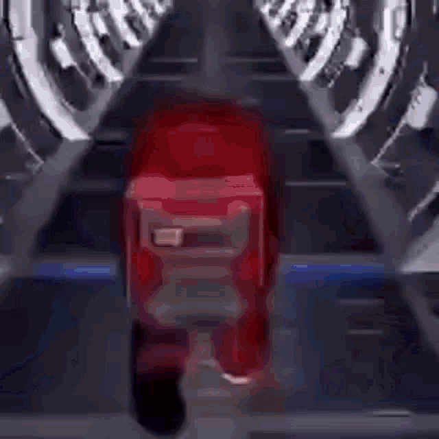 a red among us character with a backpack is running through a tunnel .