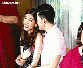 a man and a woman are sitting next to each other with the words aldubmode on the bottom right