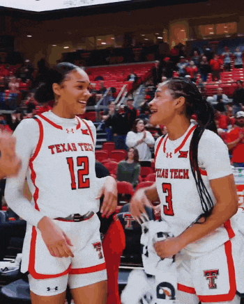 two women wearing texas tech jerseys are laughing