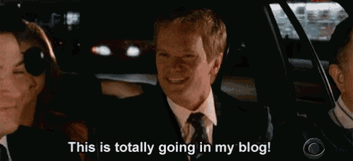 a man in a suit and tie is sitting in the back seat of a car talking to another man .