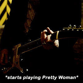 a man wearing sunglasses says " starts playing pretty woman " in a dark room