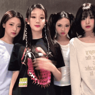 a group of young women are posing for a picture with one wearing a shirt that says ' silence '