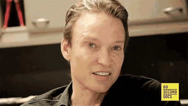 a close up of a woman 's face with a yellow sign that says 60 second docs on it