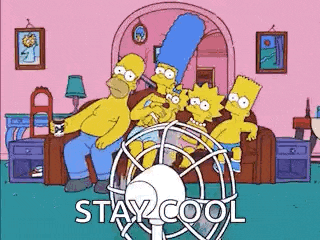 the simpsons are sitting in a living room with a fan .