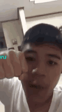 a young man with a tattoo on his fist that says yu