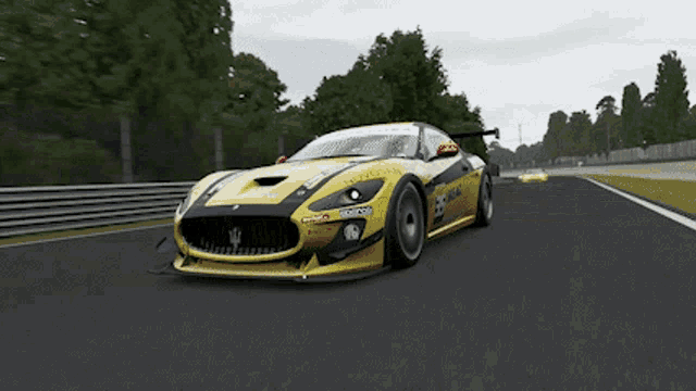 a yellow and black sports car with the word ferrari on the front