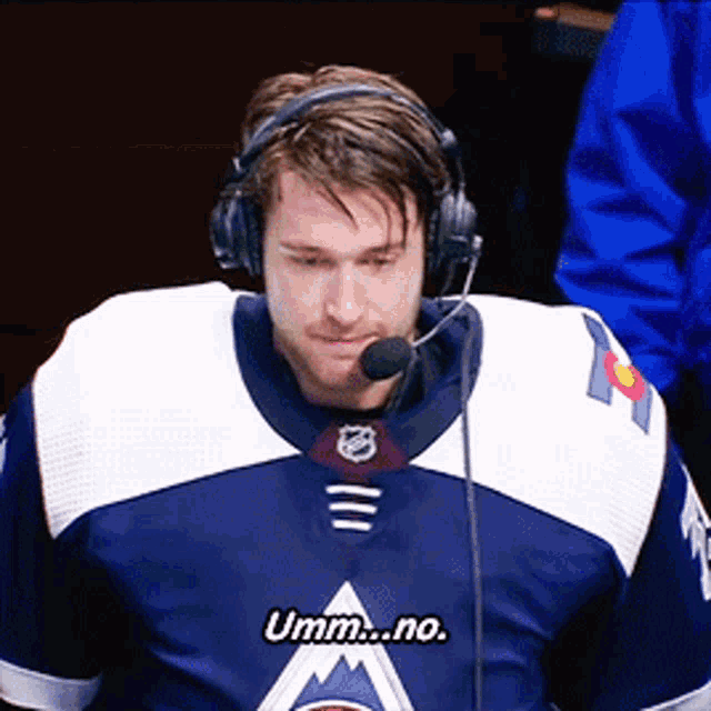 a man wearing headphones and a jersey that says umm no on it