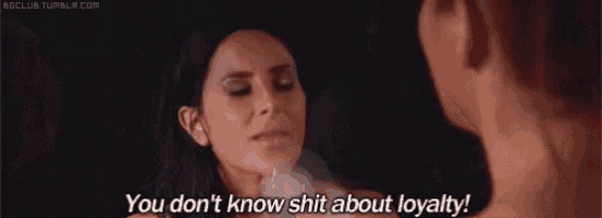 a woman is talking to a man in a dark room and says `` you don t know shit about loyalty ! ''