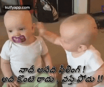 two babies with pacifiers on their faces are sitting next to each other and one of them has a pacifier in his mouth .