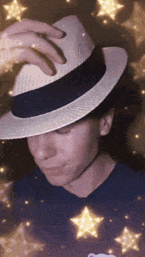 a person wearing a white hat with a blue ribbon