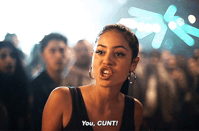a woman in a black tank top is saying you cunt