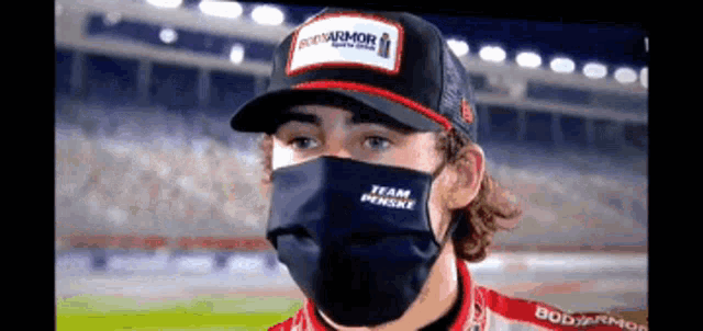 a man wearing a mask and a hat that says bud armor