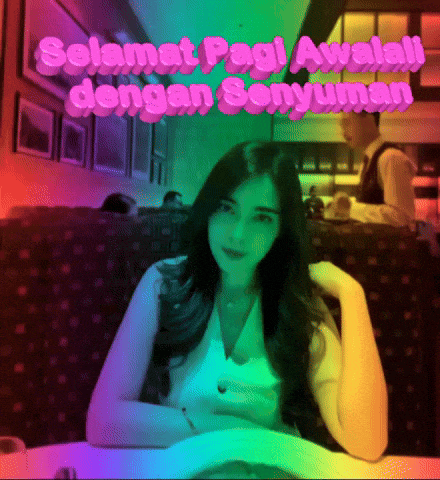 a woman sits at a table with the words " selamat pagi avalali dengan senyuman " written in pink