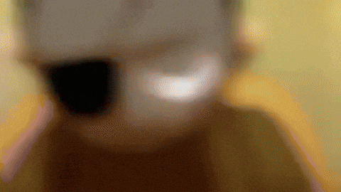 a blurred image of a person 's face with a yellow background