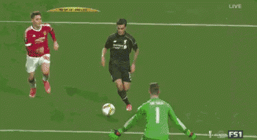 a soccer game is being played and the goalie is kneeling down