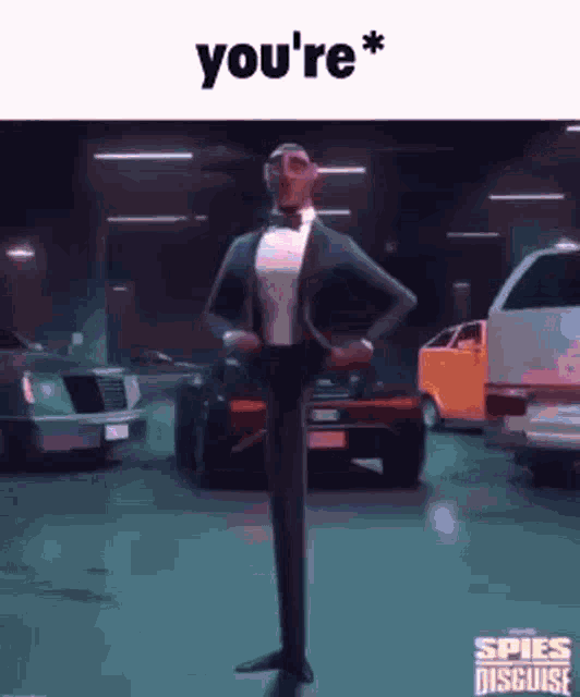 a man in a tuxedo and bow tie is standing in a parking garage with cars .
