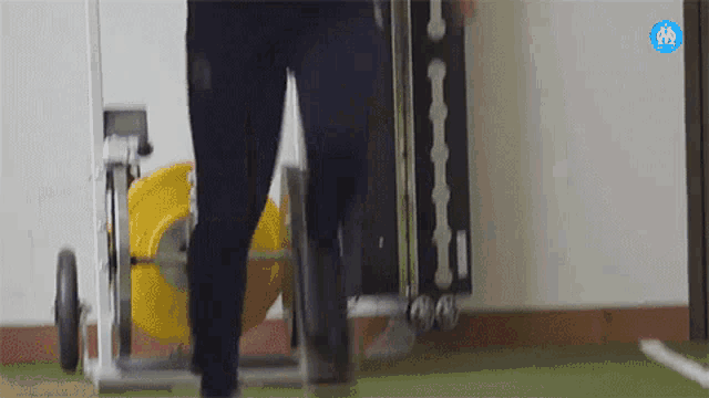 a person is pushing a cart with a sign that says ' athletic ' on it .