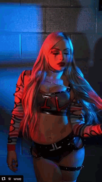 a woman in a wrestling outfit with the letters i and l on her chest