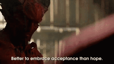 a person with blood on their face is saying `` better to embrace acceptance than hope . ''