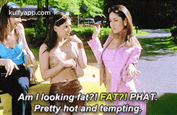 three women are standing next to each other on a yellow car and talking .