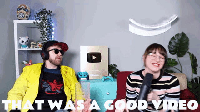 a man and a woman are sitting on a couch with the words that was a good video above them