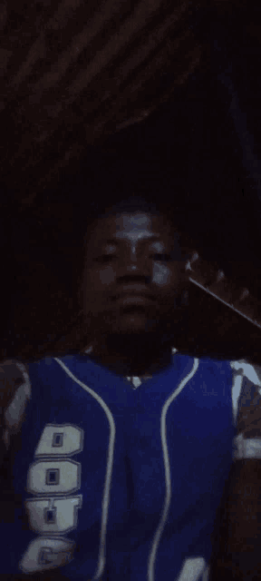 a man wearing a blue jersey that says aop