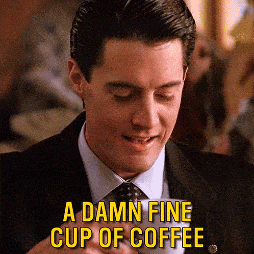 a man in a suit and tie is saying a damn fine cup of coffee