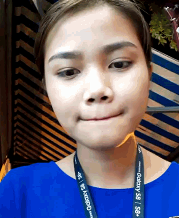 a woman wearing a lanyard with galaxy s8 on it