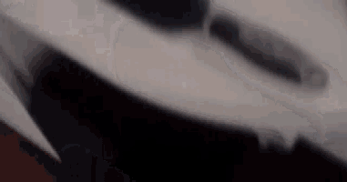 a blurred image of a person 's face with a black background