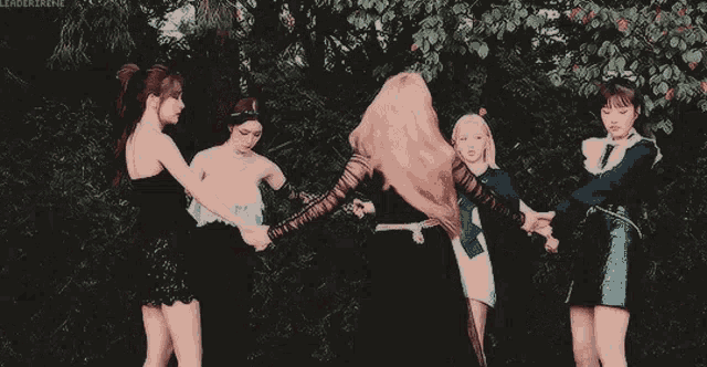 a group of women are standing next to each other holding hands