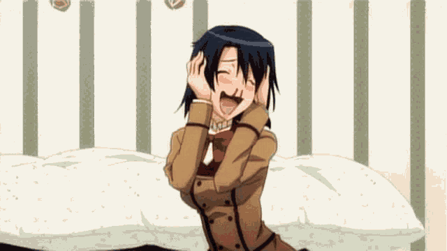 a girl is sitting on a bed covering her ears with her hands and smiling .