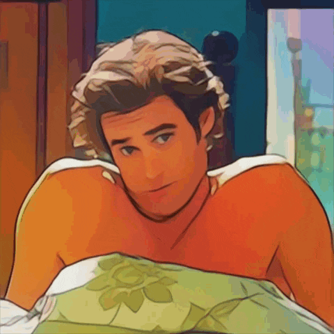 a man without a shirt is laying in bed with a green blanket