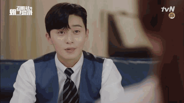 a man in a suit and tie looks at a woman in a tvn ad