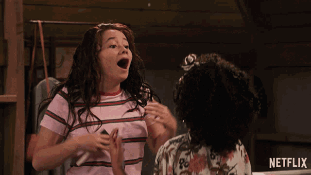 two girls are playing with each other with a netflix logo in the background